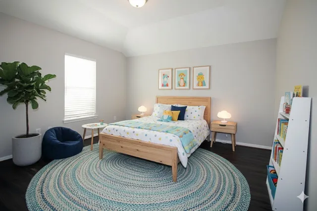 a bedroom with a bed and a potted plant