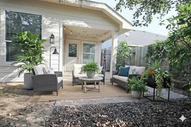 a view of a patio with couches table and chairs and potted plants