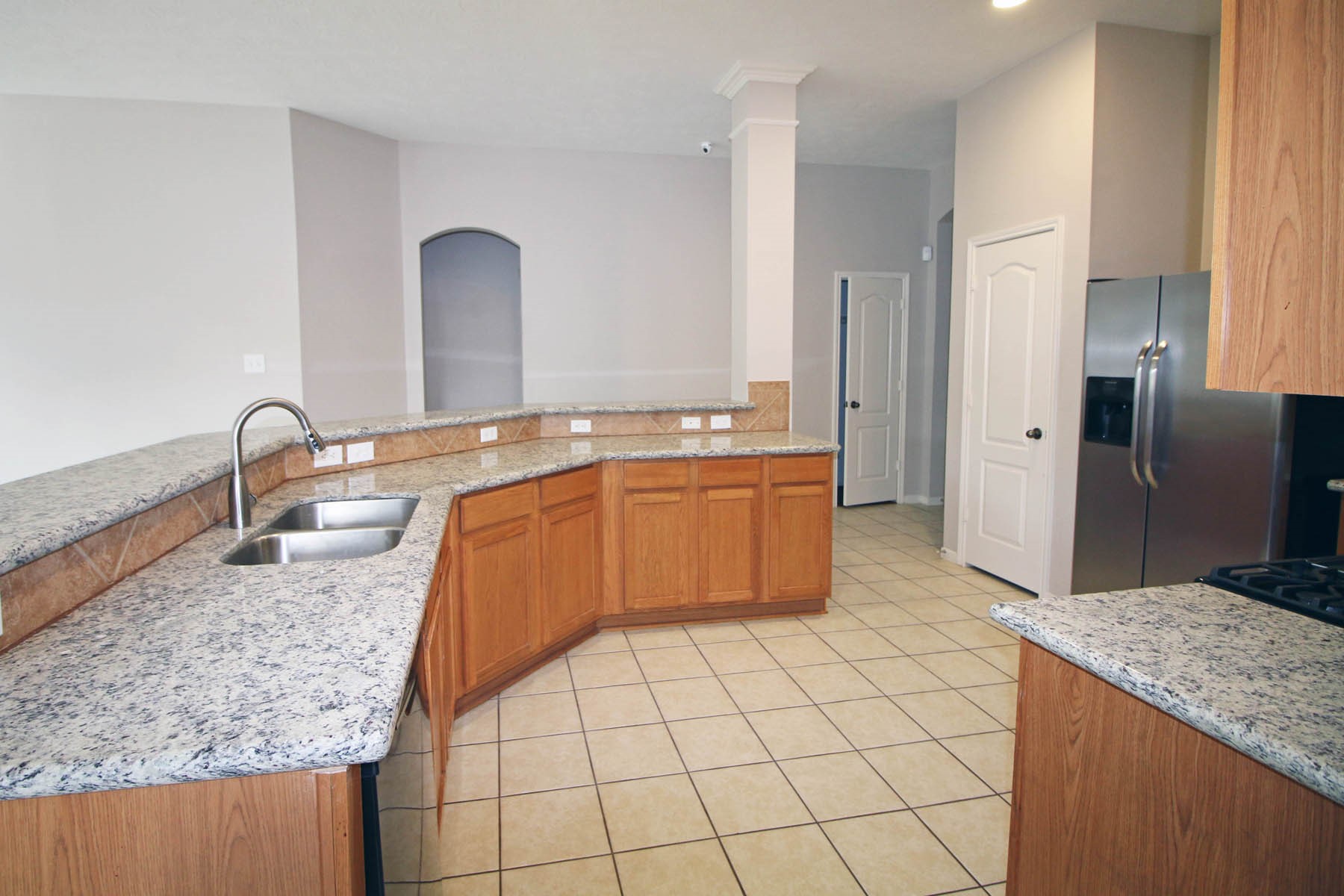 21743 May Apple Court Cypress, TX 77433 - Photo 2 of 15 a kitchen with stainless steel appliances granite countertop a sink stove and refrigerator