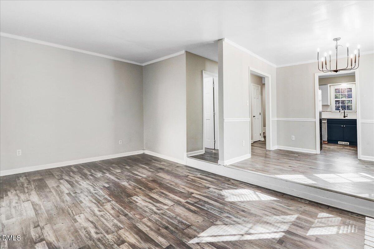 4715 Mallory Court Raleigh, NC 27616 - Photo 8 of 31 a view of an empty room with kitchen and window