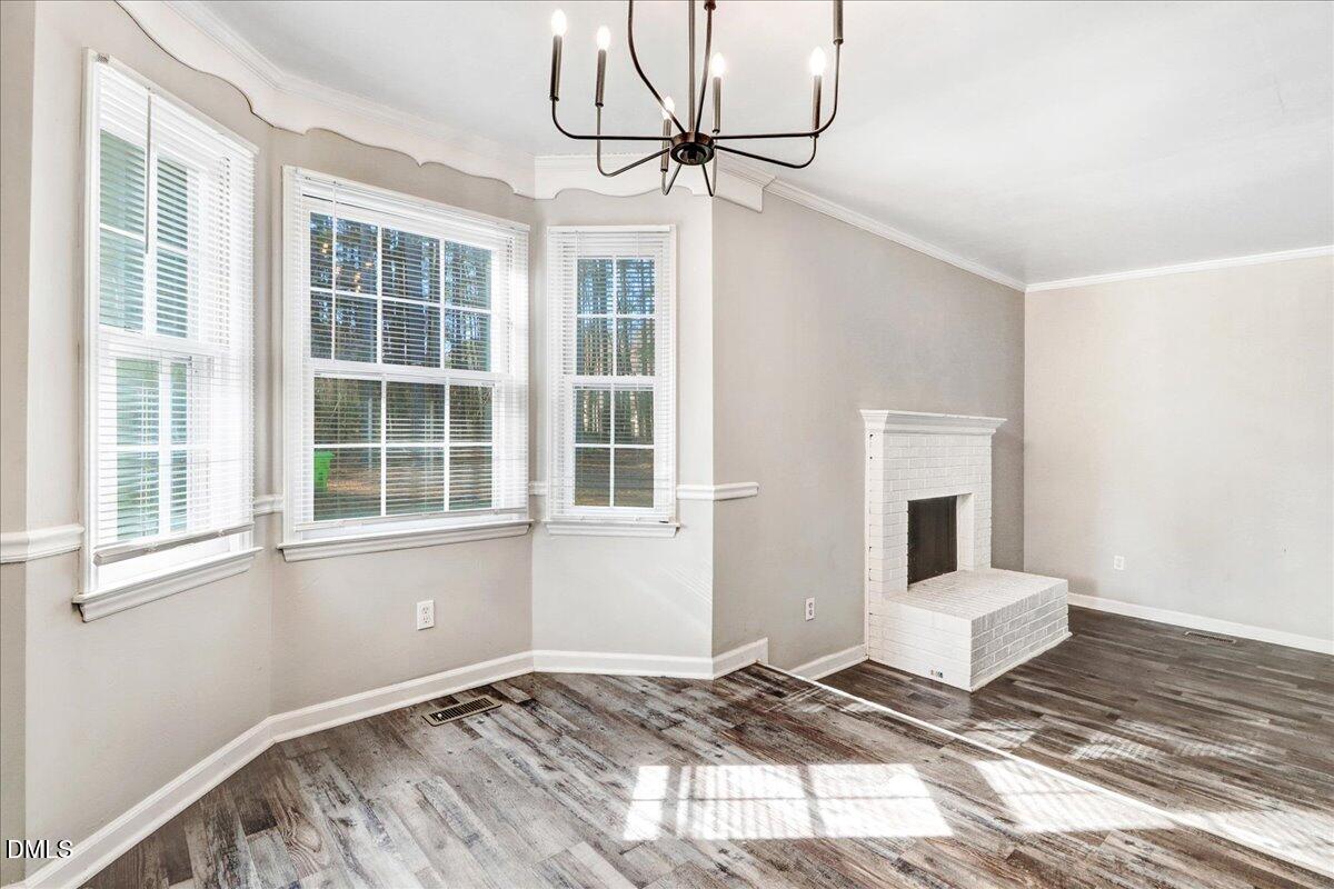 4715 Mallory Court Raleigh, NC 27616 - Photo 10 of 31 a view of a bedroom with a bed and wooden floor