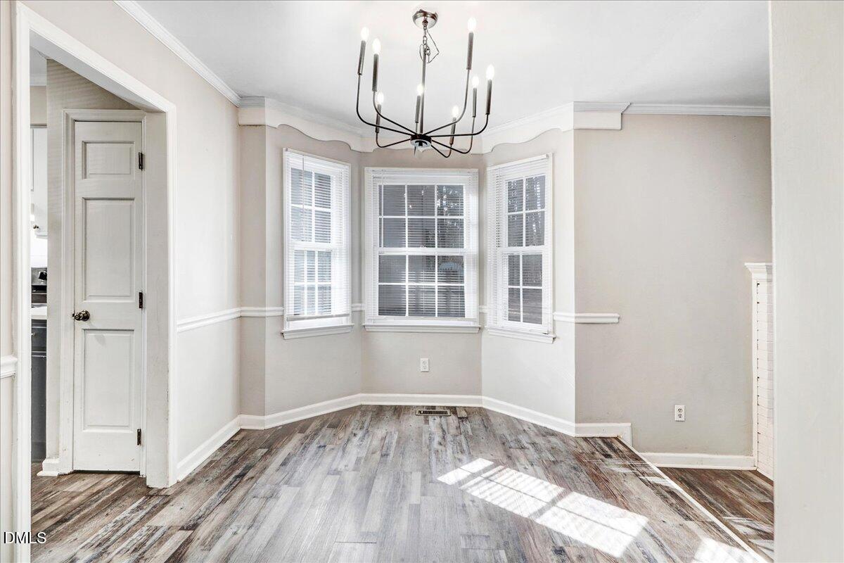 4715 Mallory Court Raleigh, NC 27616 - Photo 11 of 31 a view of empty room with wooden floor and windows