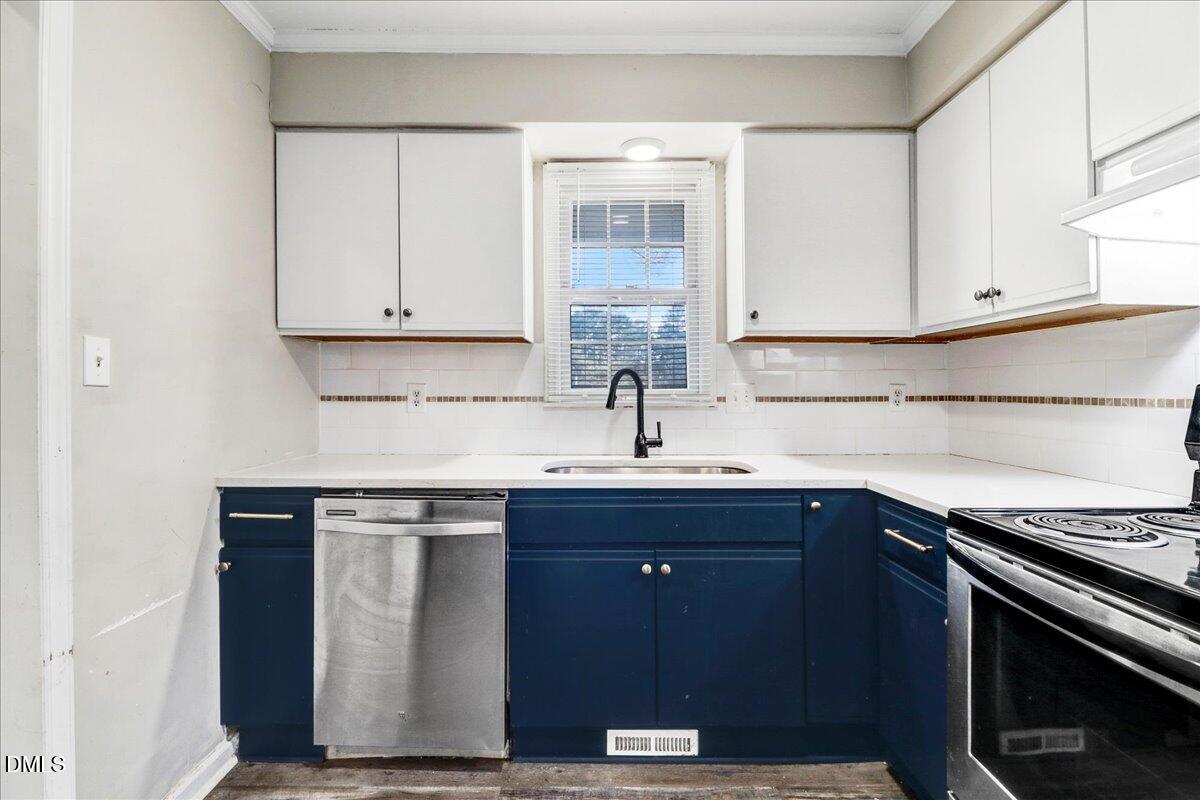 4715 Mallory Court Raleigh, NC 27616 - Photo 13 of 31 a kitchen with a sink cabinets and stainless steel appliances