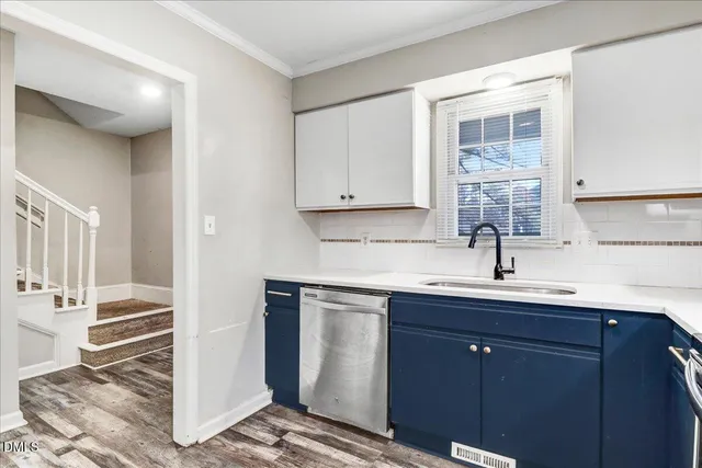 a kitchen with a sink cabinets and stainless steel appliances