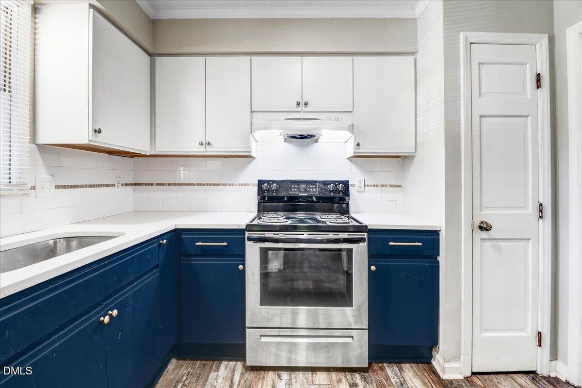 4715 Mallory Court Raleigh, NC 27616 - Photo 16 of 31 a kitchen with granite countertop white cabinets and black appliances