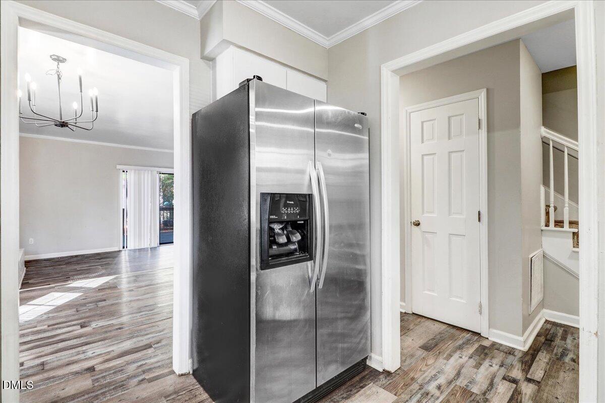 4715 Mallory Court Raleigh, NC 27616 - Photo 17 of 31 a view of a refrigerator in kitchen and an empty room