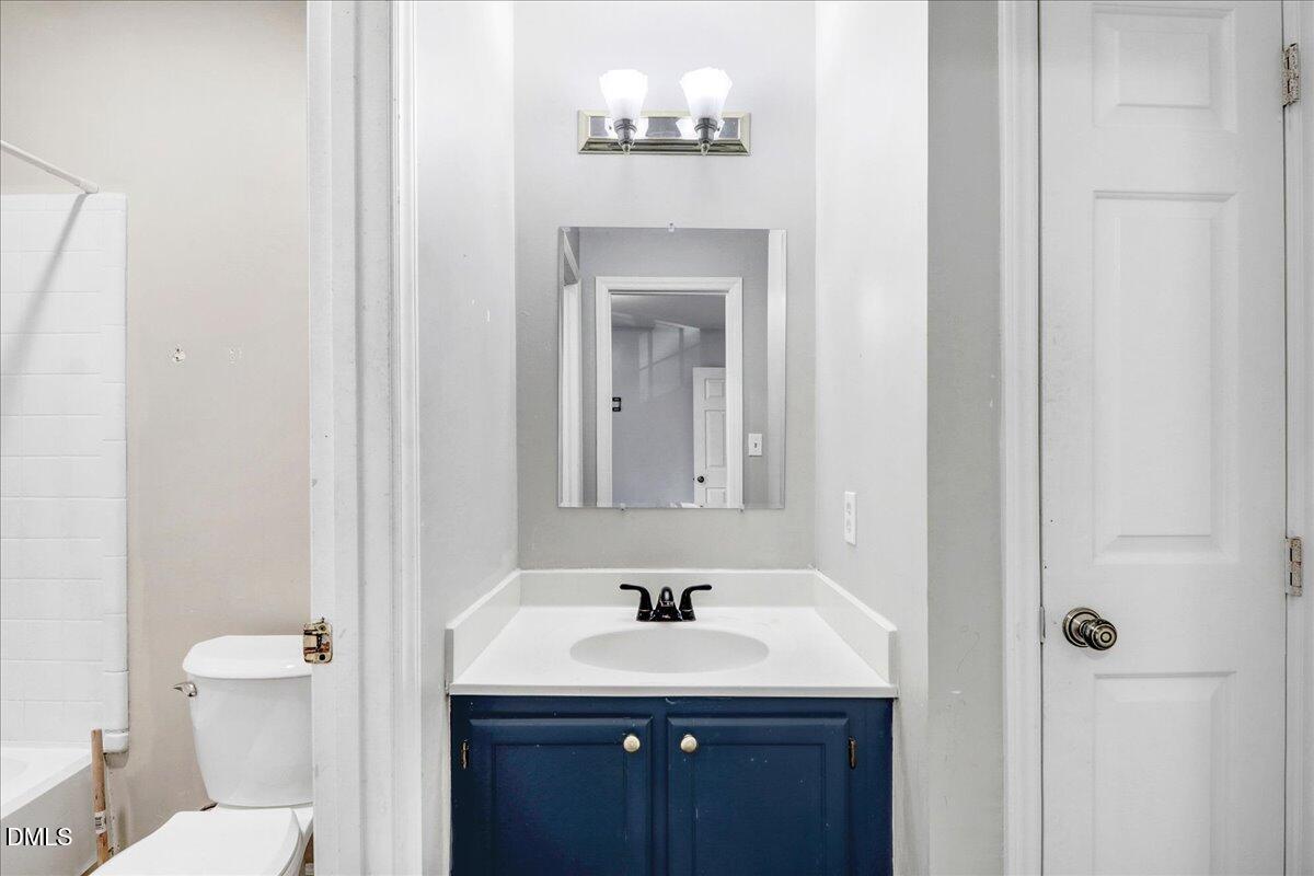 4715 Mallory Court Raleigh, NC 27616 - Photo 20 of 31 a bathroom with a sink and a mirror with toilet