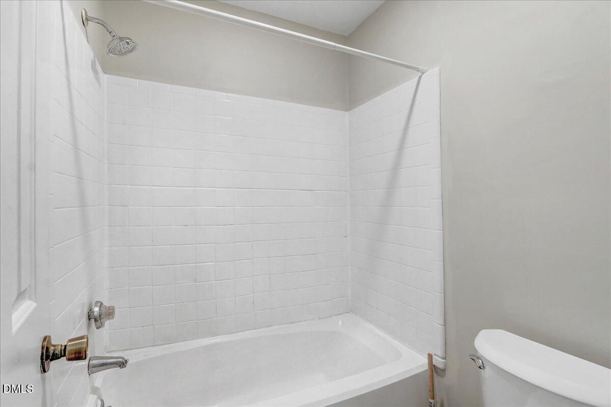 4715 Mallory Court Raleigh, NC 27616 - Photo 21 of 31 a close up of a bathtub in a bathroom