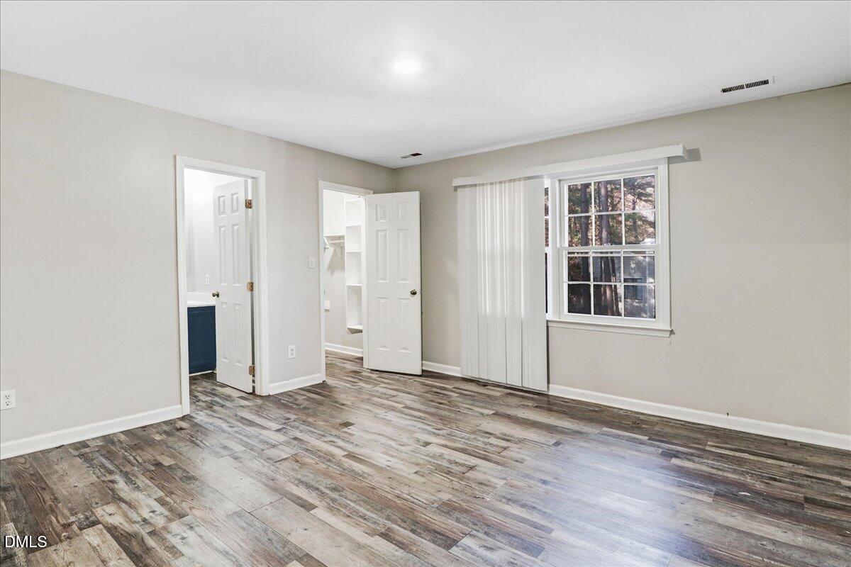 4715 Mallory Court Raleigh, NC 27616 - Photo 22 of 31 a view of an empty room with window and wooden floor