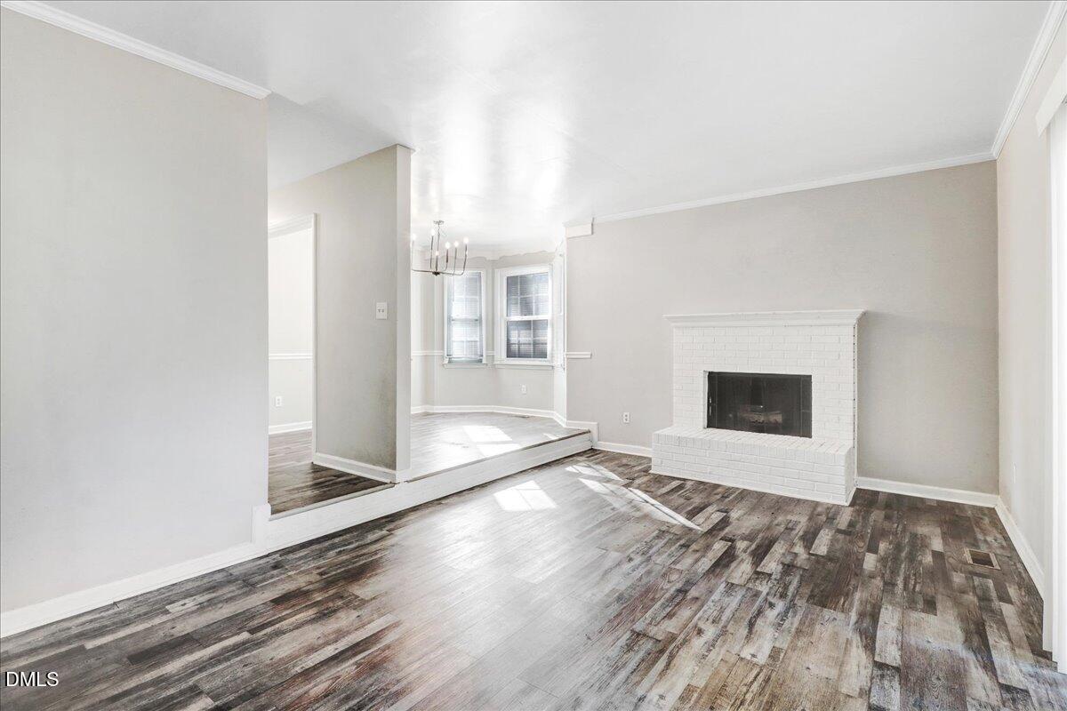 4715 Mallory Court Raleigh, NC 27616 - Photo 6 of 31 a view of an empty room with wooden floor and a window