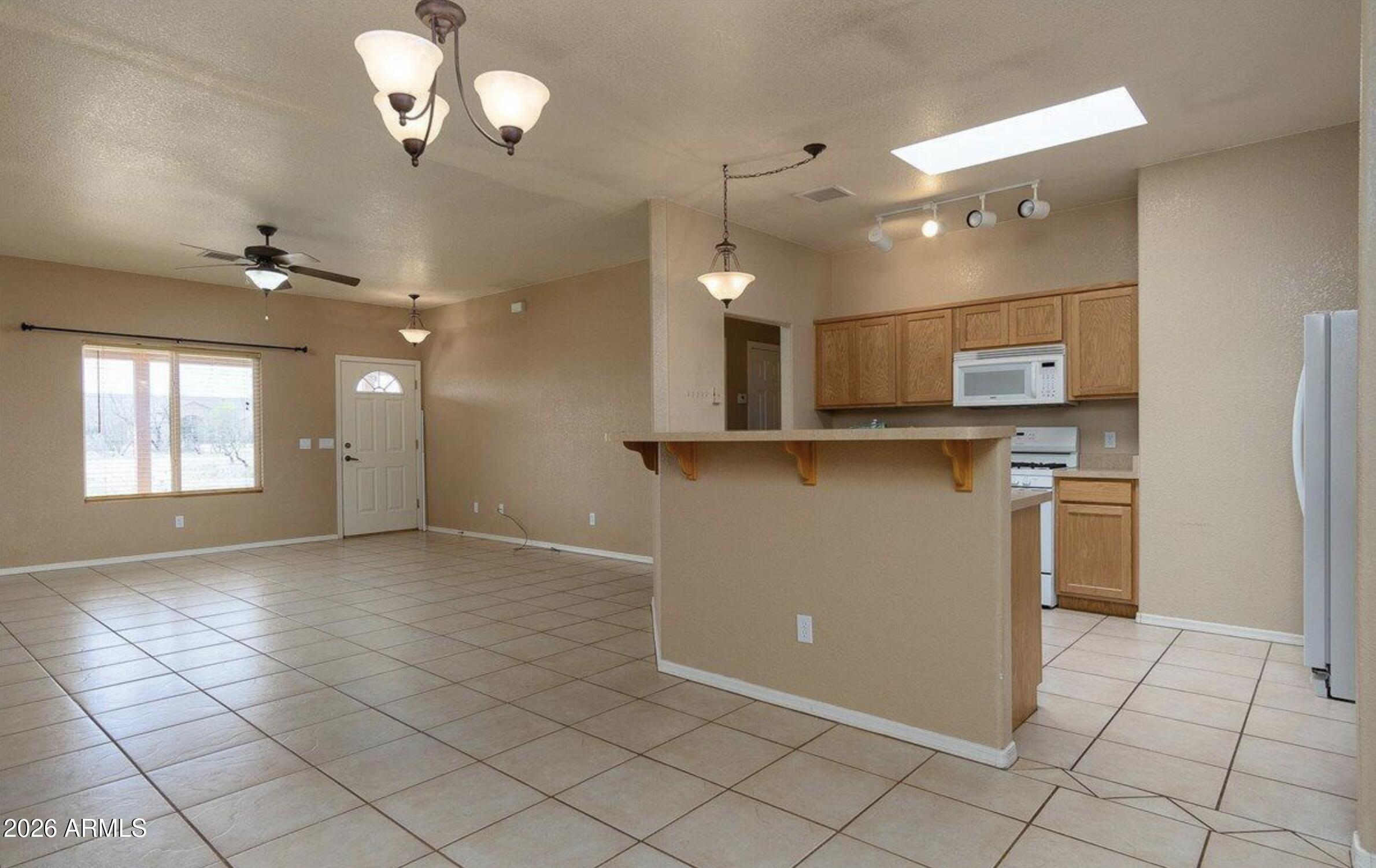 10193 East Windtalker Road Hereford, AZ 85615 - Photo 3 of 34 a view of a kitchen with a sink and stainless steel appliances