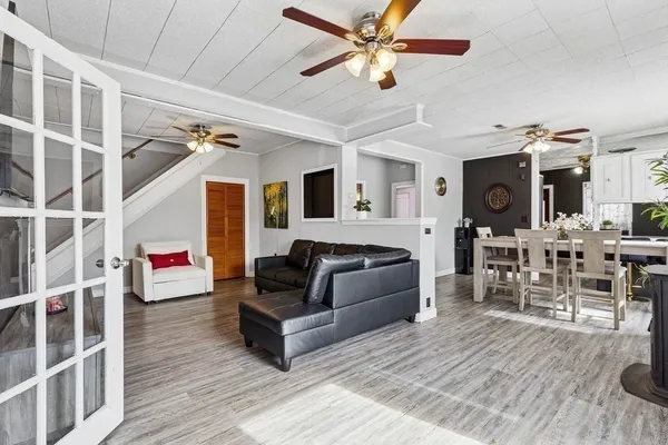 a living room with furniture and wooden floor