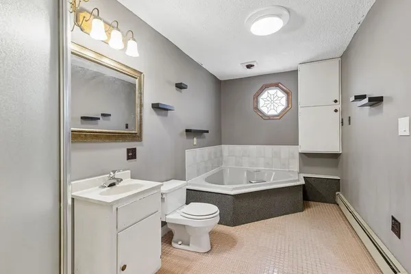 a bathroom with a sink a toilet and a mirror