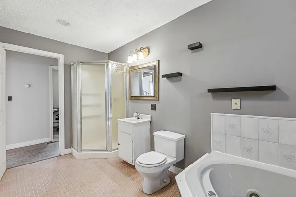 a white toilet sitting next to a bathroom sink and tub