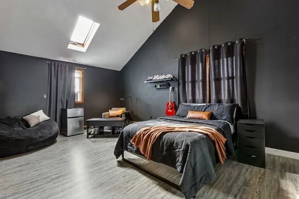 a bedroom with a bed and a chandelier