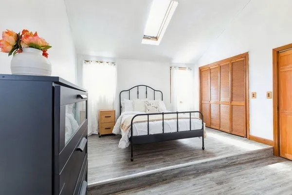 a bedroom with a bed and a window