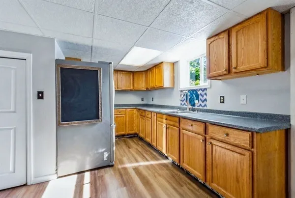 a bathroom with a granite countertop toilet sink and mirror