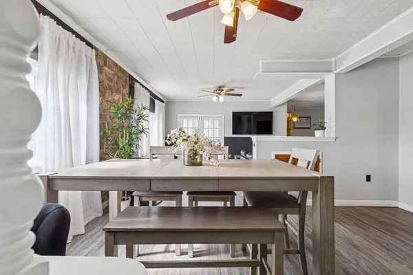 a kitchen with kitchen island stainless steel appliances a dining table and chairs