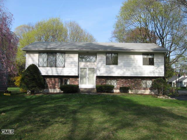 12 Ridge Road Danbury, CT 06810 - Photo 1 of 1 a front view of a house with a garden and plants