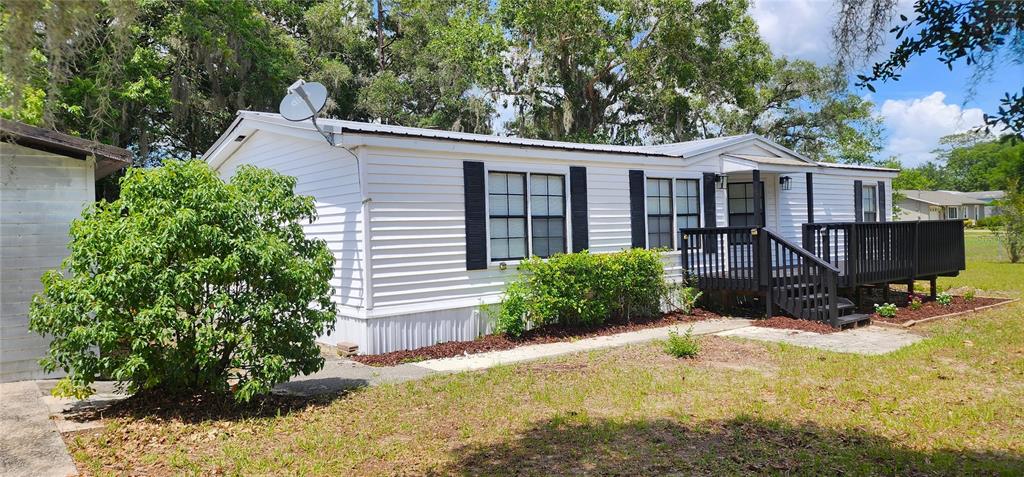 19865 Southwest 5th Place Dunnellon, FL 34431 - Photo 2 of 78 a view of a house with a yard and sitting area