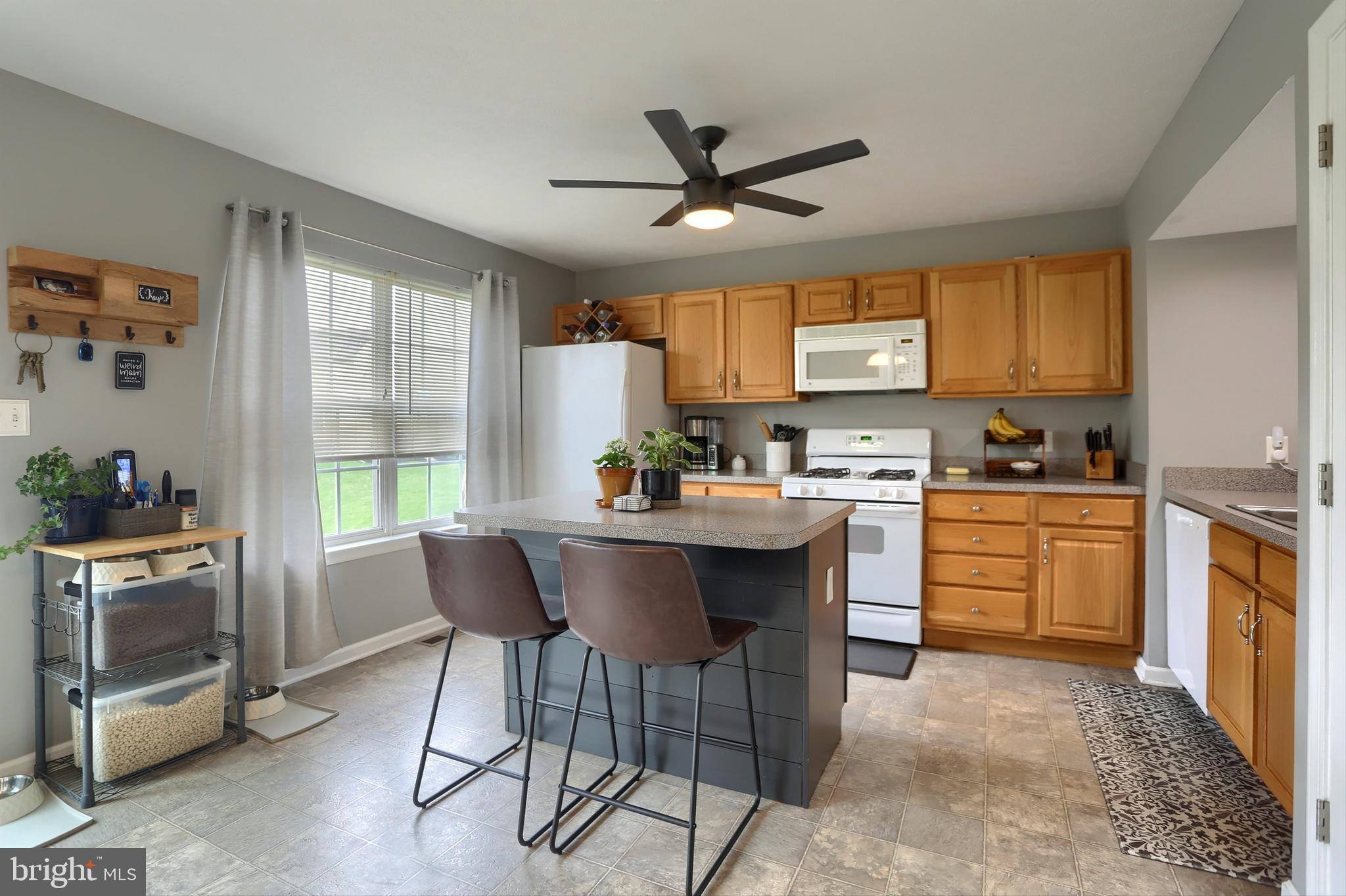 120 East Beaver Street York, PA 17406 - Photo 15 of 41 a kitchen with a stove a sink a dining table and chairs