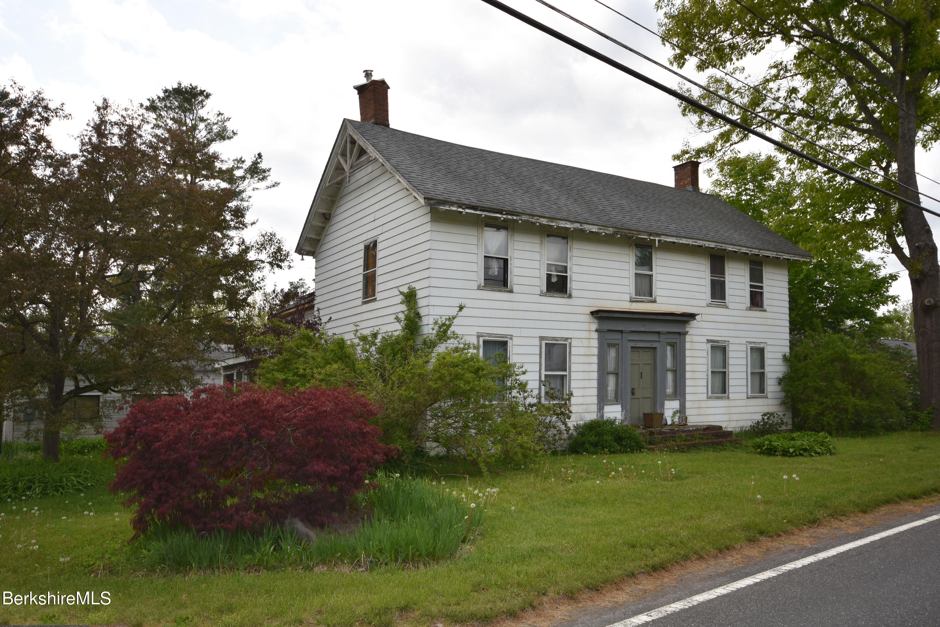 110 Tyringham Road Lee, MA 01238 - Photo 1 of 60 a front view of a house with a garden