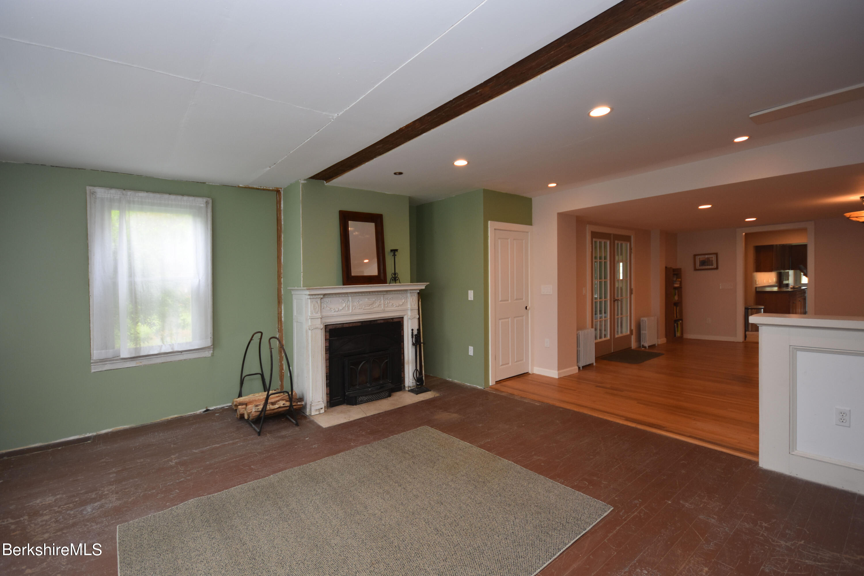 110 Tyringham Road Lee, MA 01238 - Photo 24 of 60 a view of an empty room with a fireplace and a window