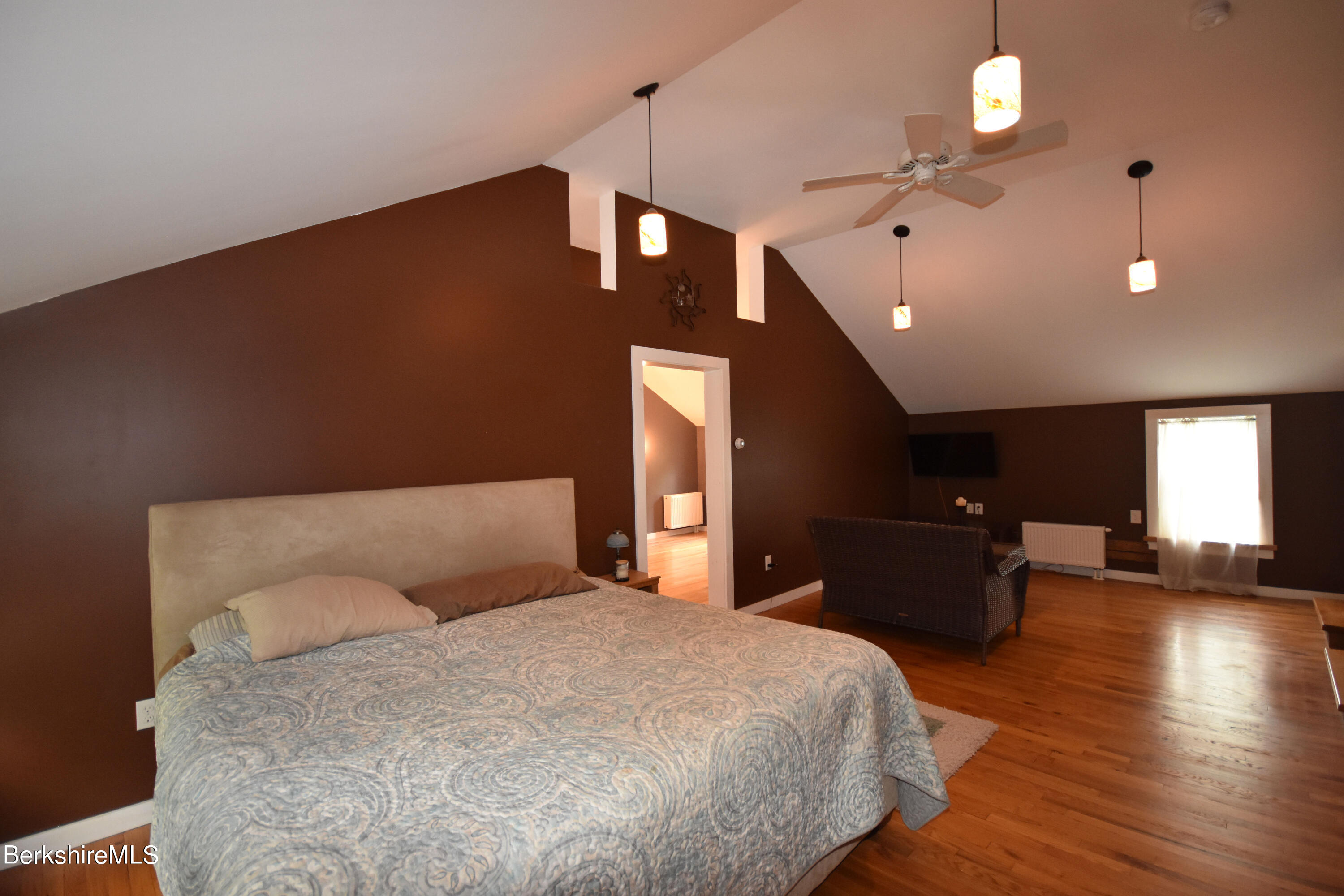 110 Tyringham Road Lee, MA 01238 - Photo 27 of 60 a bedroom with a bed and a chandelier