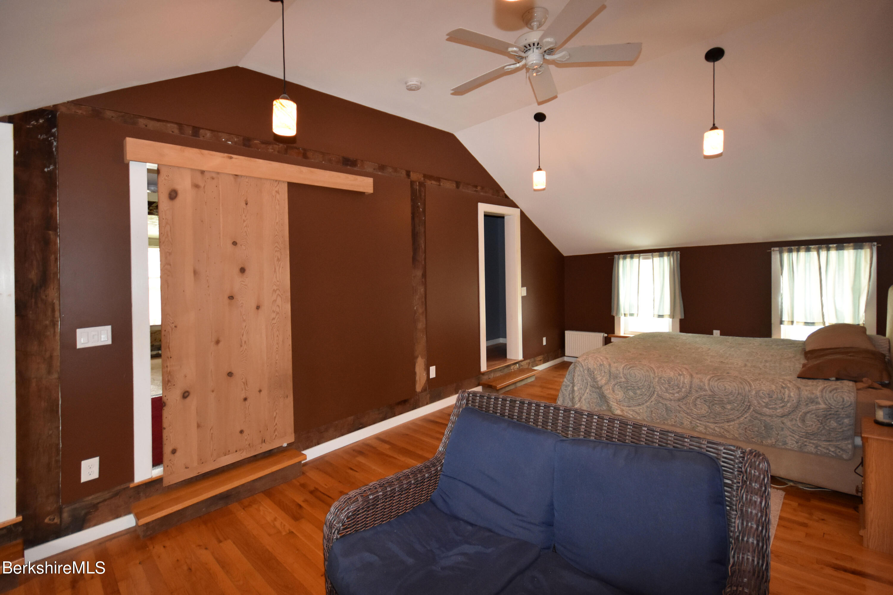 110 Tyringham Road Lee, MA 01238 - Photo 29 of 60 a bed room with a bed and a chandelier