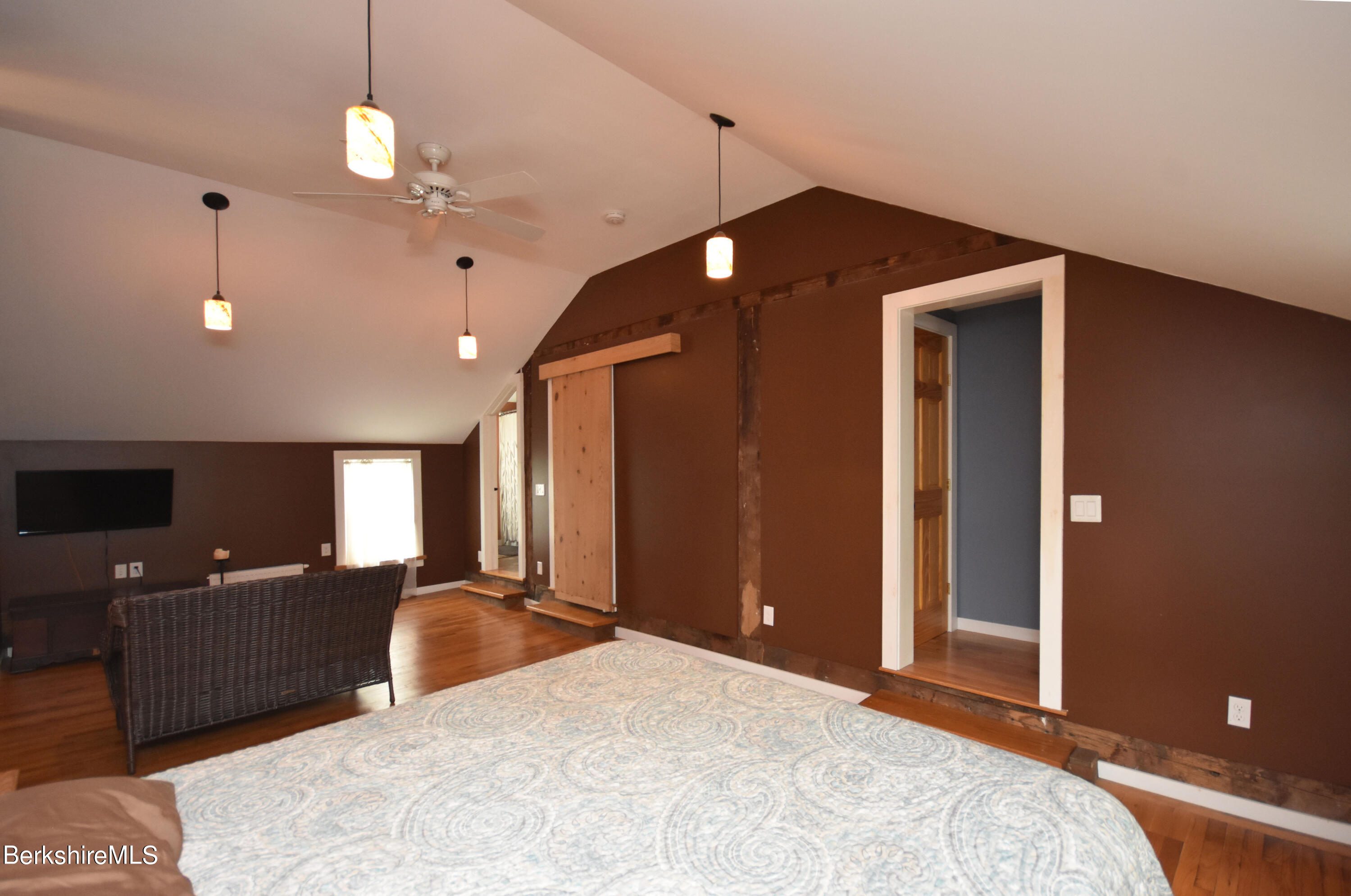 110 Tyringham Road Lee, MA 01238 - Photo 30 of 60 a bedroom with a bed and a chandelier