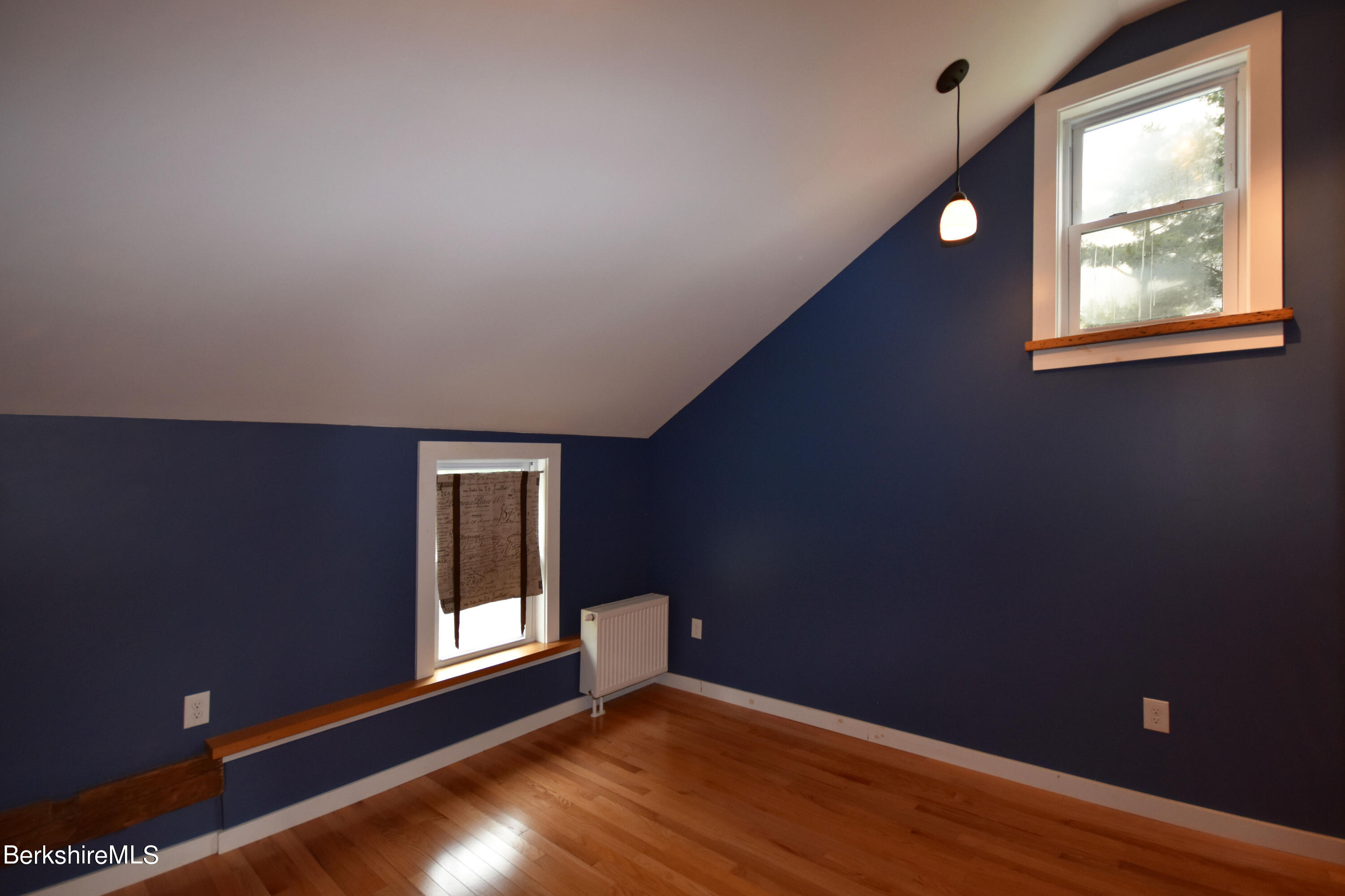 110 Tyringham Road Lee, MA 01238 - Photo 35 of 60 a view of an empty room with wooden floor and a window