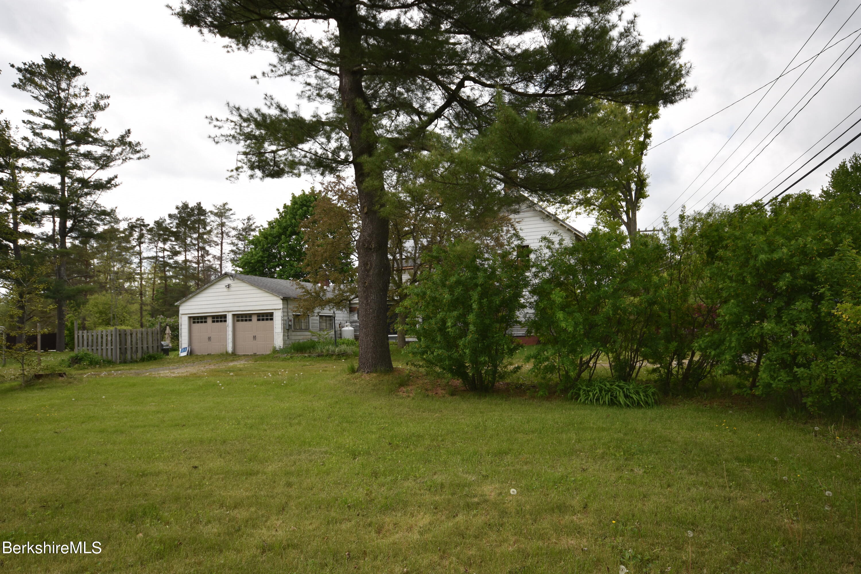 110 Tyringham Road Lee, MA 01238 - Photo 51 of 60 a view of a big yard with plants and large trees
