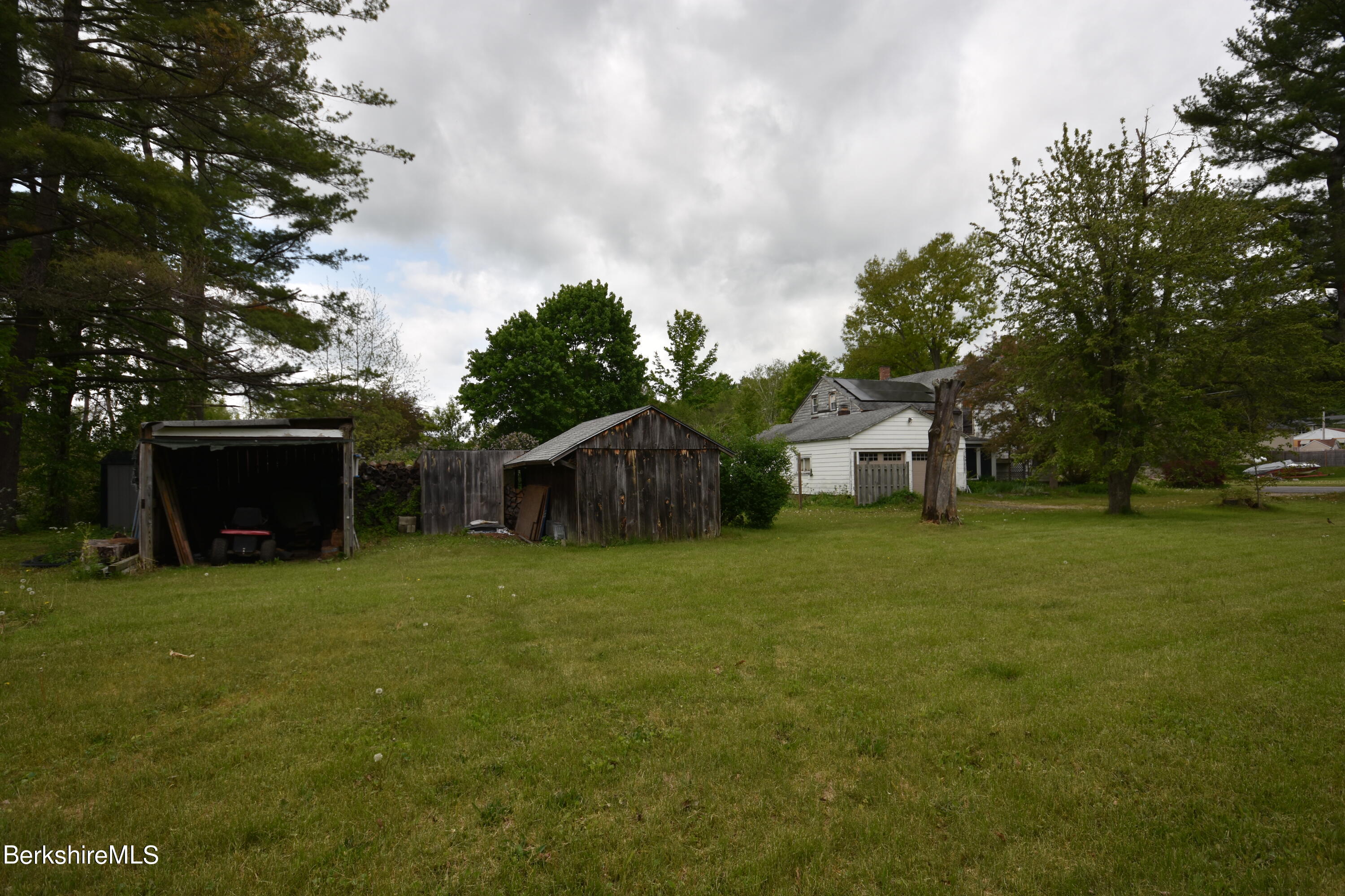 110 Tyringham Road Lee, MA 01238 - Photo 58 of 60 a front view of a house with a garden and trees