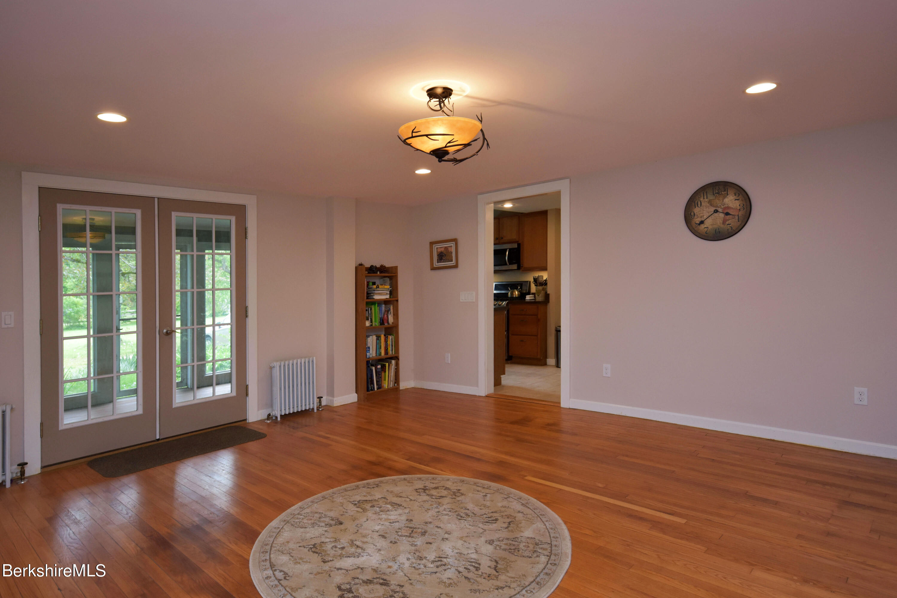 110 Tyringham Road Lee, MA 01238 - Photo 6 of 60 an empty room with wooden floor chandelier fan and windows