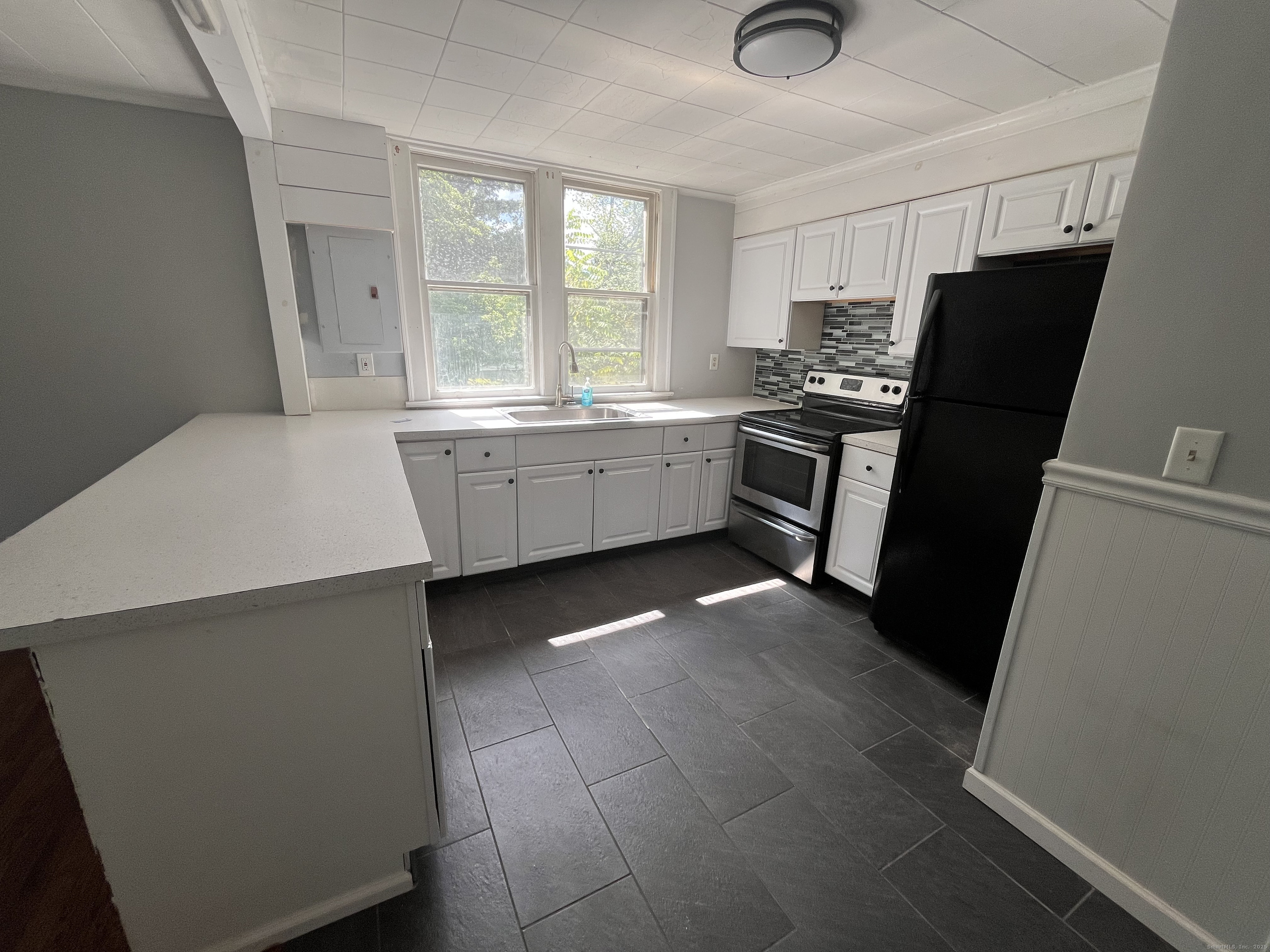 486 Mohegan Ave Parkway Quaker Hill, CT 06375 - Photo 3 of 8 a kitchen with a refrigerator and a sink