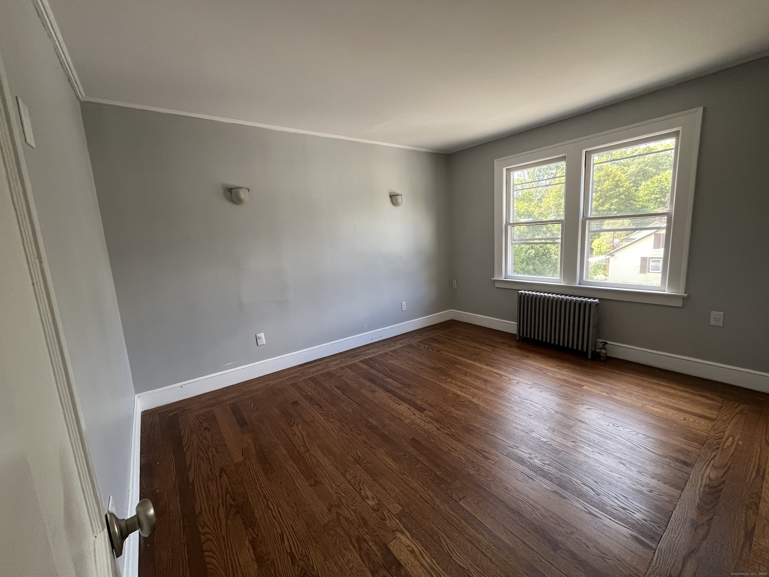 486 Mohegan Ave Parkway Quaker Hill, CT 06375 - Photo 4 of 8 an empty room with wooden floor and windows