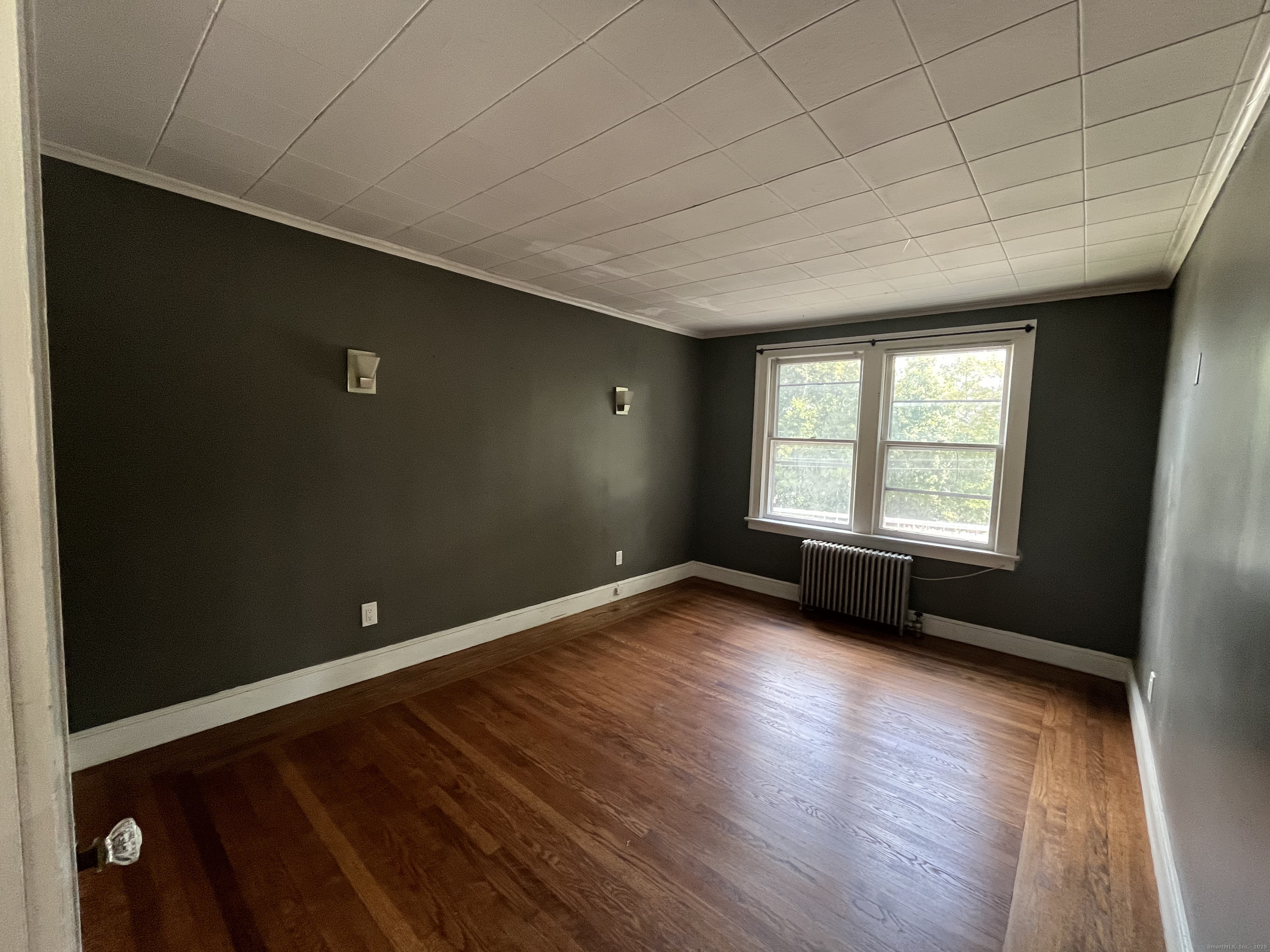 486 Mohegan Ave Parkway Quaker Hill, CT 06375 - Photo 5 of 8 an empty room with wooden floor and windows