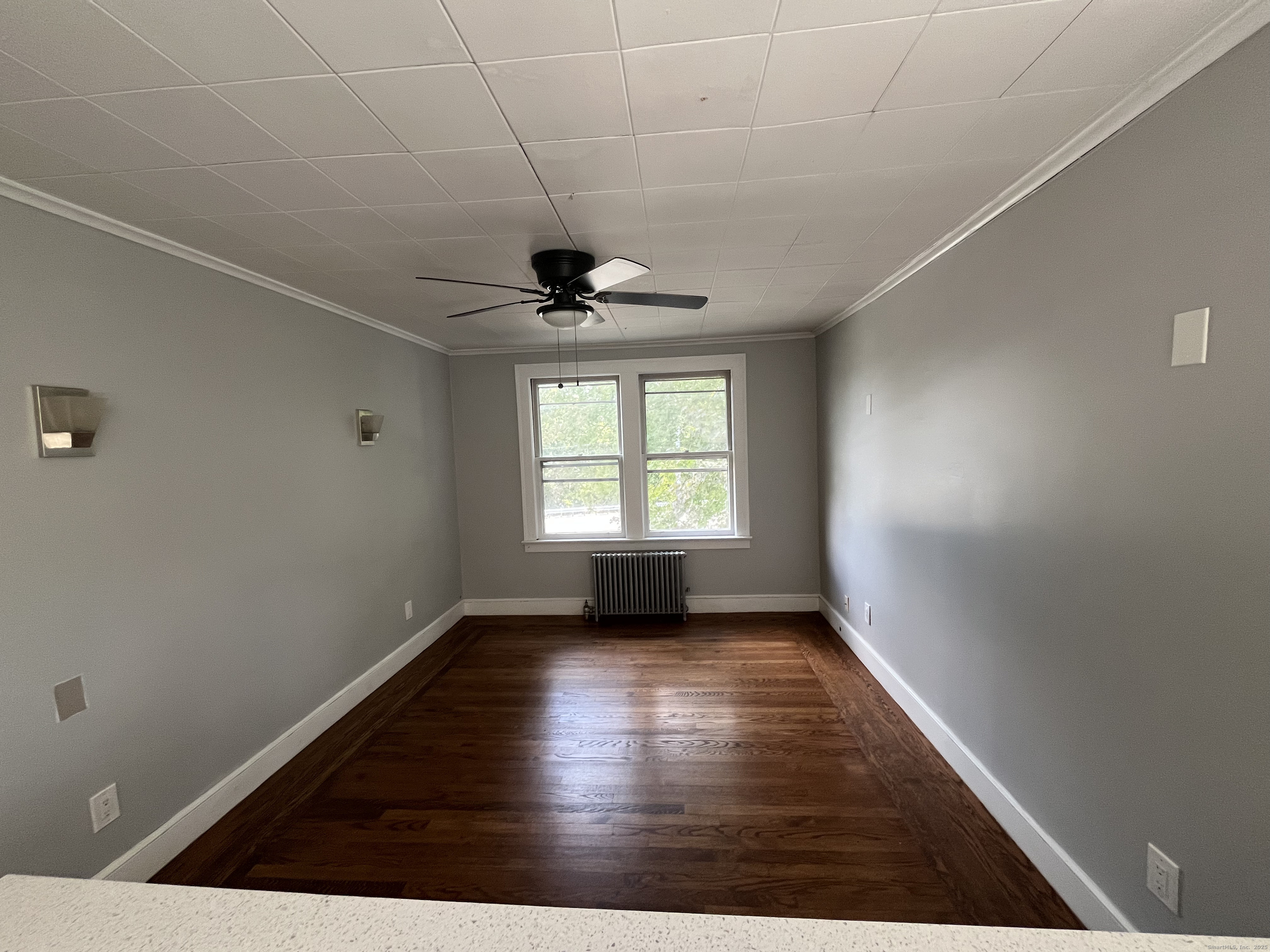 486 Mohegan Ave Parkway Quaker Hill, CT 06375 - Photo 6 of 8 an empty room with wooden floor and windows