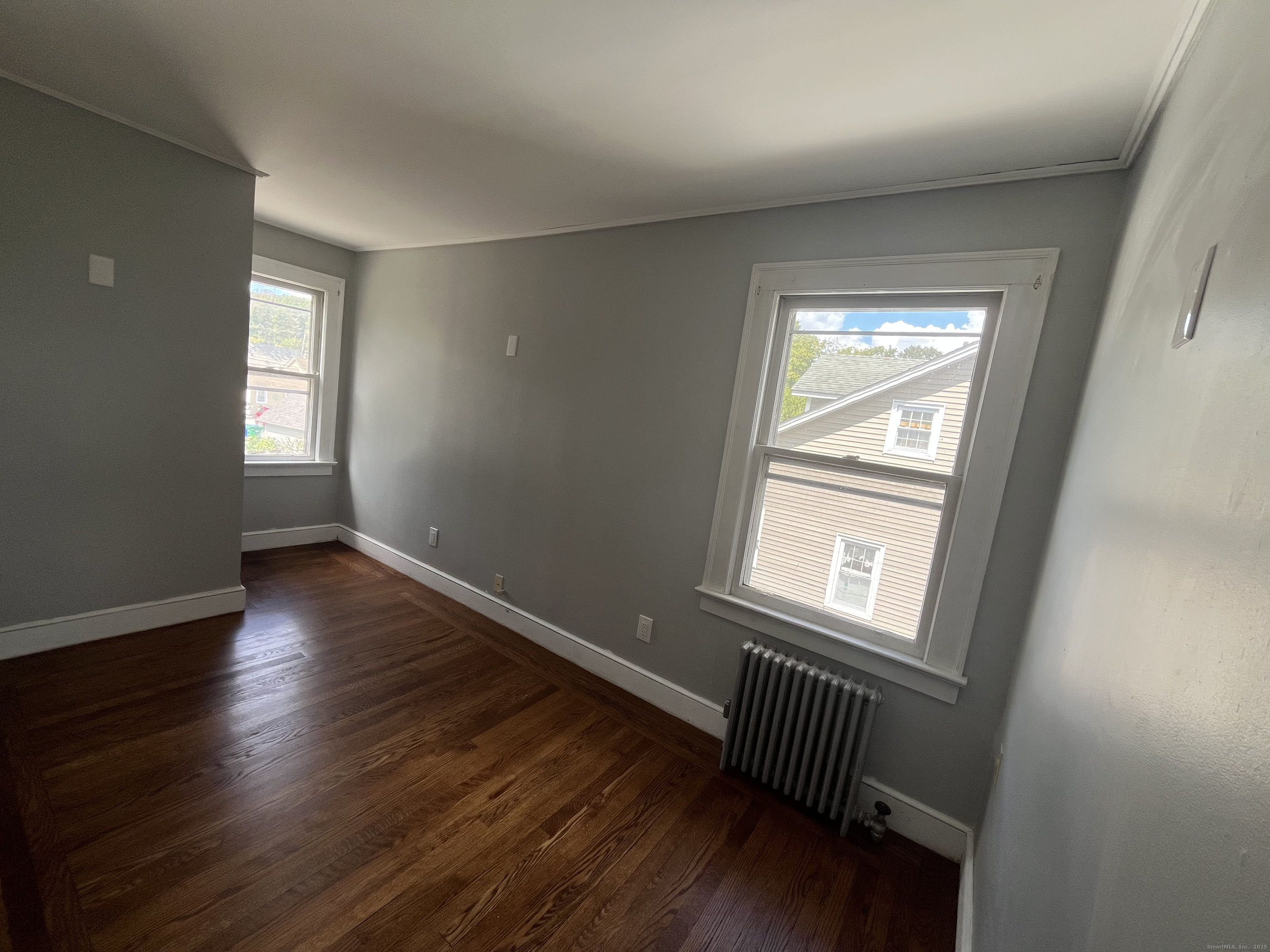 486 Mohegan Ave Parkway Quaker Hill, CT 06375 - Photo 7 of 8 a view of wooden floor and windows in a room