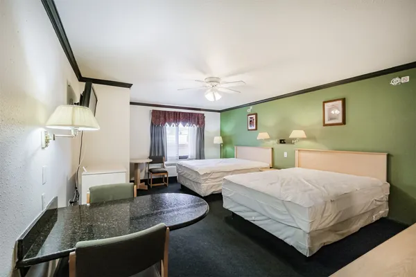 a bedroom with a bed and window