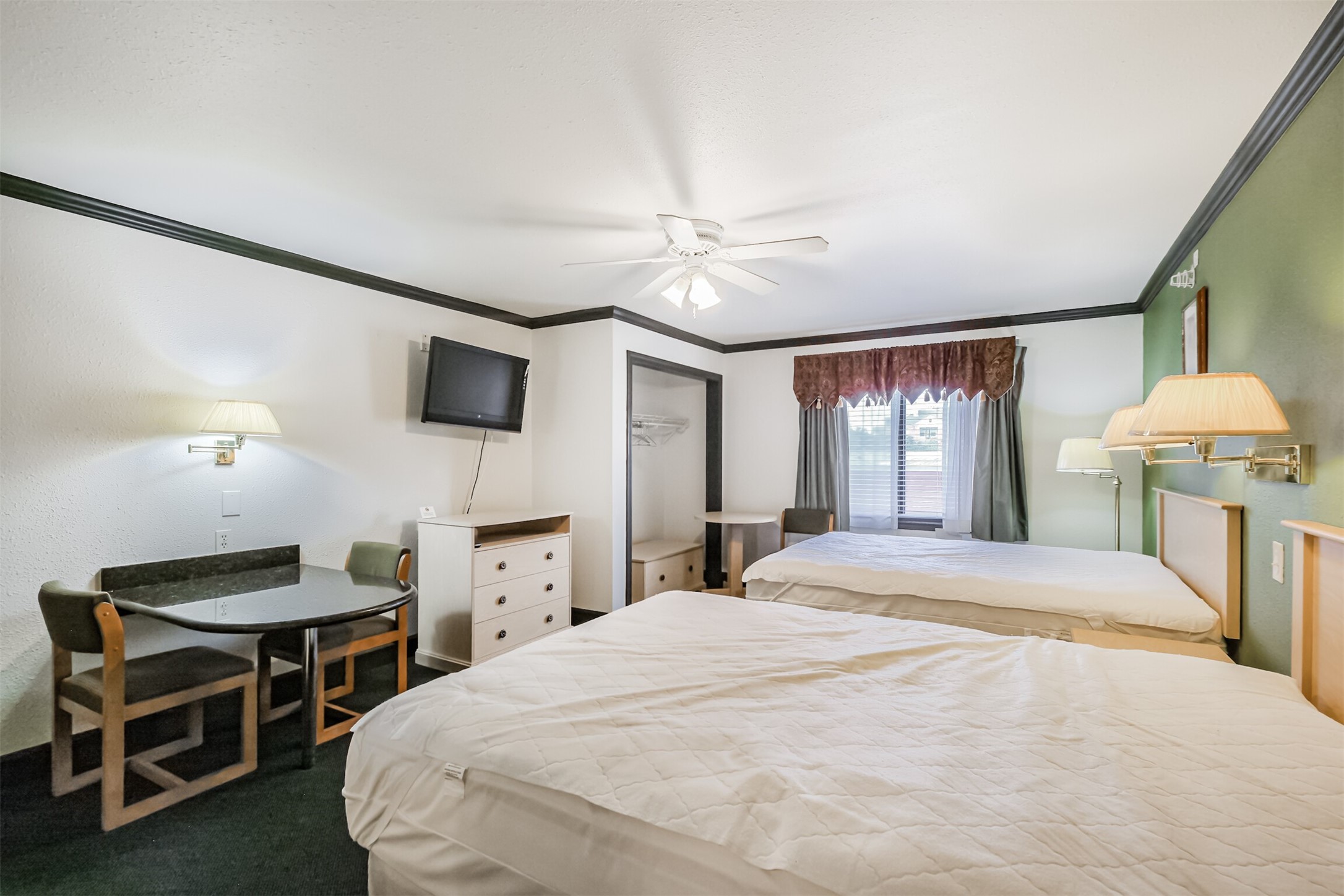 1025 Swanson Street, Unit 210 Houston, TX 77030 - Photo 12 of 19 a bedroom with a bed and a chandelier