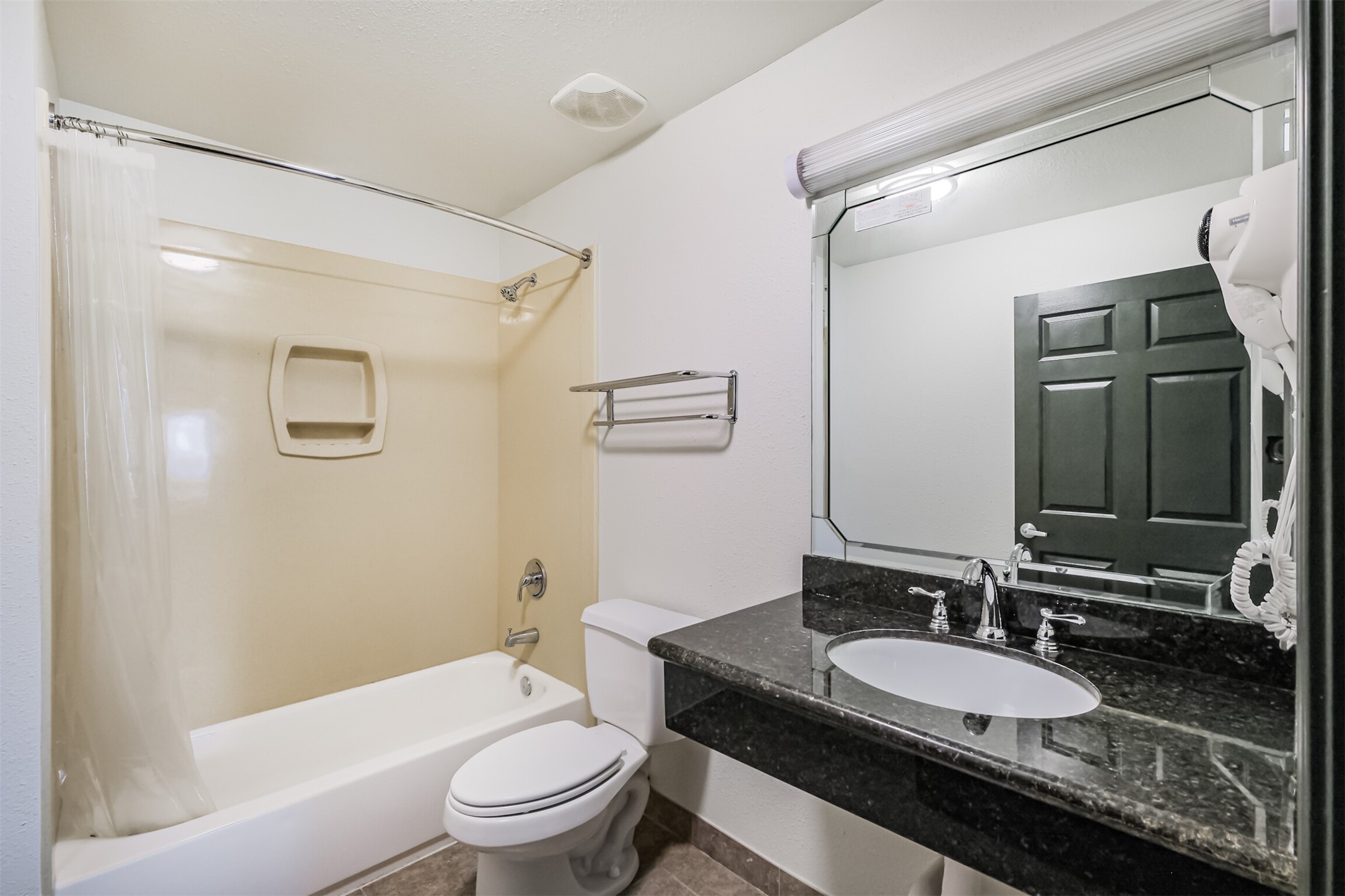 1025 Swanson Street, Unit 210 Houston, TX 77030 - Photo 15 of 19 a bathroom with a granite countertop sink toilet a mirror and shower
