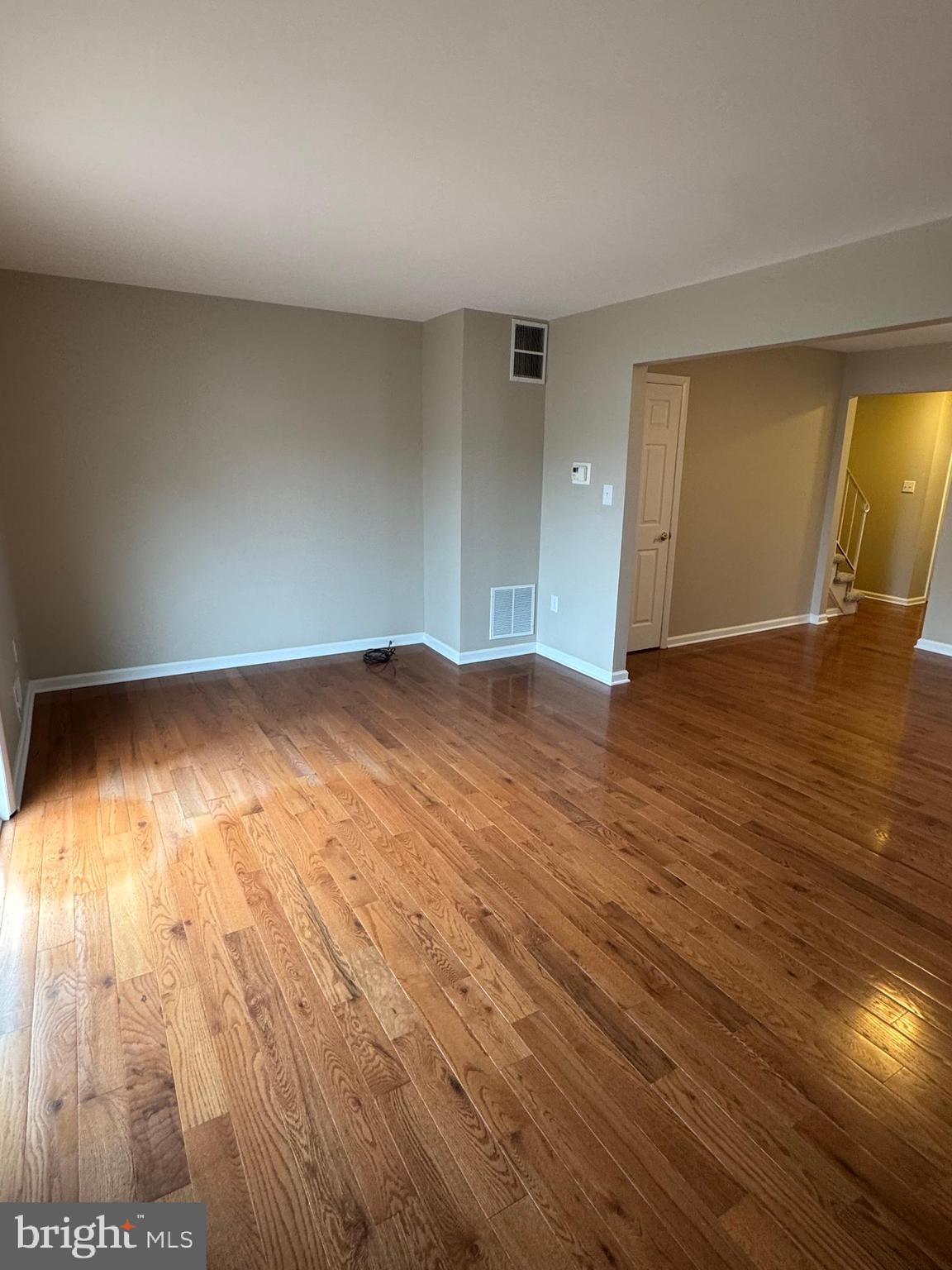 116 Reeger Avenue Hamilton, NJ 08610 - Photo 12 of 25 an empty room with wooden floor and windows