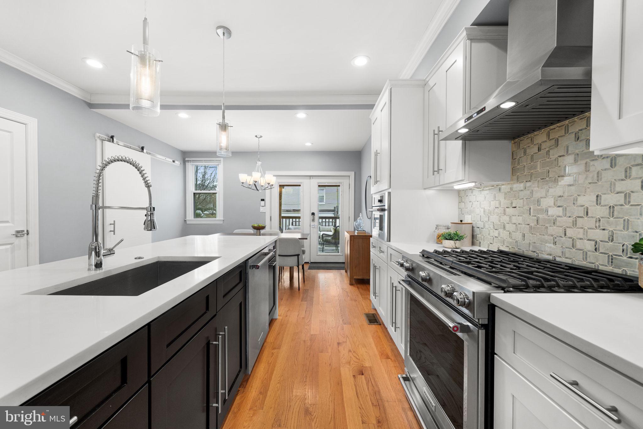 5302 7th Street Northwest Washington, DC 20011 - Photo 11 of 45 a kitchen with stainless steel appliances a sink stove and cabinets