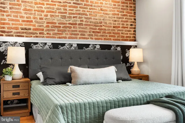 a bedroom with a bed and a night stand