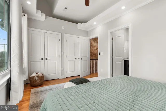 a bedroom with a bed and a large mirror