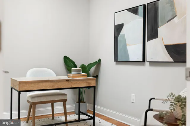 a dining room with furniture and wooden floor