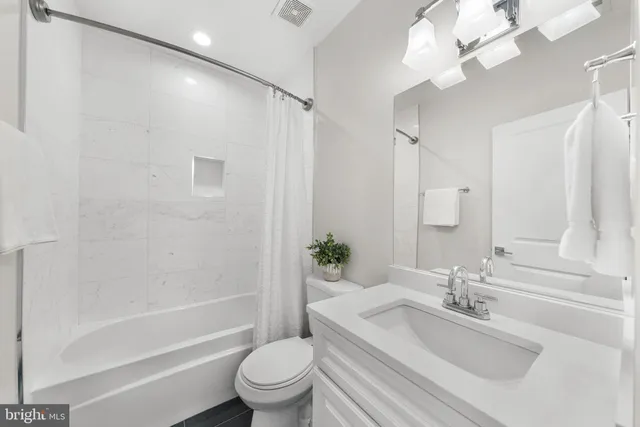 a bathroom with a sink a toilet and a bathtub