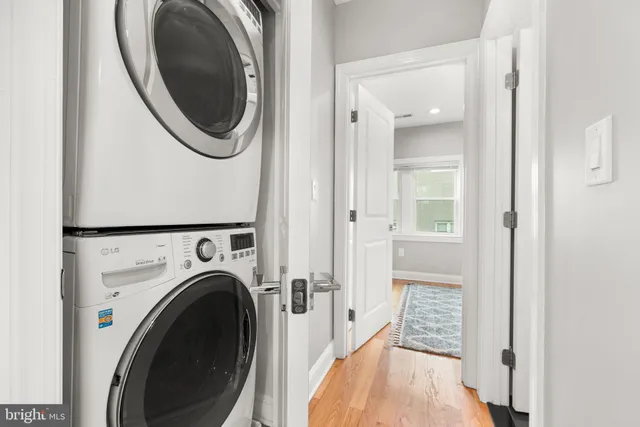 a view of a hallway with washer and dryer