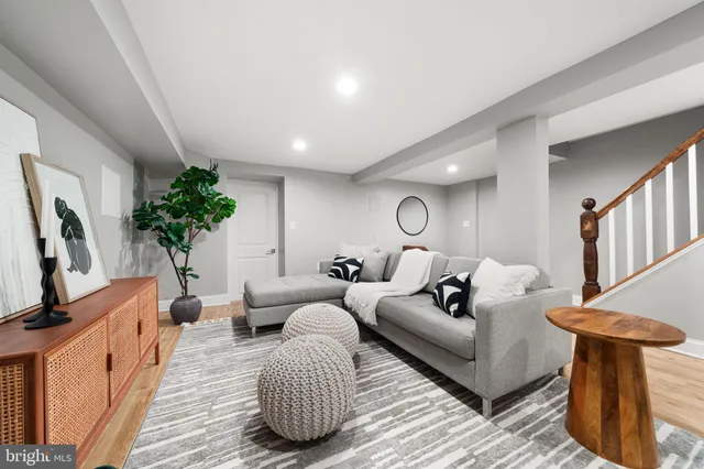 a living room with furniture a potted plant and a fireplace